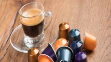 Berlin, Germany - January 23, 2015: Cup of Coffee with Nestle Nespresso Capsules on a wooden table
