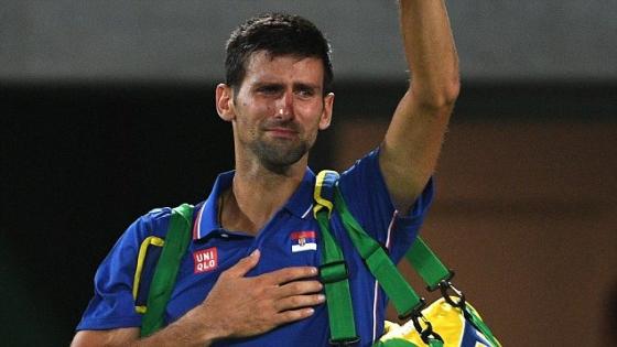 TOPSHOT - Serbia's Novak Djokovic waves to the crowd with tears in his eyes after losing his men's first round singles tennis match against Argentina's Juan Martin Del Potro at the Olympic Tennis Centre of the Rio 2016 Olympic Games in Rio de Janeiro on August 7, 2016. / AFP PHOTO / Roberto SCHMIDTROBERTO SCHMIDT/AFP/Getty Images