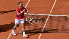 Serbia's Novak Djokovic reacts to beating Spain's Carlos Alcaraz in their men's singles final tennis match on Court Philippe-Chatrier at the Roland-Garros Stadium during the Paris 2024 Olympic Games, in Paris on August 4, 2024. (Photo by Miguel MEDINA / AFP)