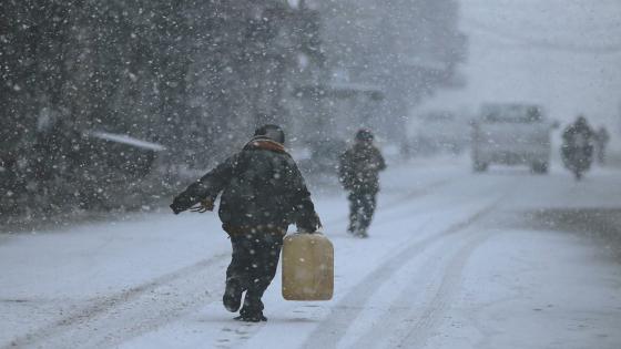A boy walks on snow as he holds a plastic gallon during snow fall in the Duma neighbourhood of Damascus, December 13, 2013. A powerful winter storm sweeping the eastern Mediterranean this week is causing mayhem across the region and inflicting extra hardships on Syrians convulsed in civil war and on refugees who have fled the fighting.The storm, named Alexa, is expected to last until Saturday, bringing more snow, rain and cold to swathes of Turkey, Syria, Lebanon, Jordan, Israel, the Palestinian territories and Egypt. REUTERS/Bassam Khabieh (SYRIA - Tags: POLITICS CIVIL UNREST) - RTX16H55